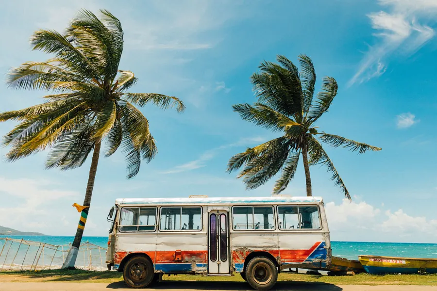 Tropical beach in Jamaica with turquoise water and palm trees — Jamaica packs extraordinary landscapes into a small island