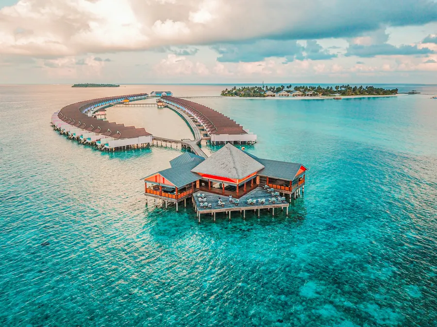 Overwater bungalows in the Maldives at sunrise — the quintessential image of the Maldives' dry season from November to April